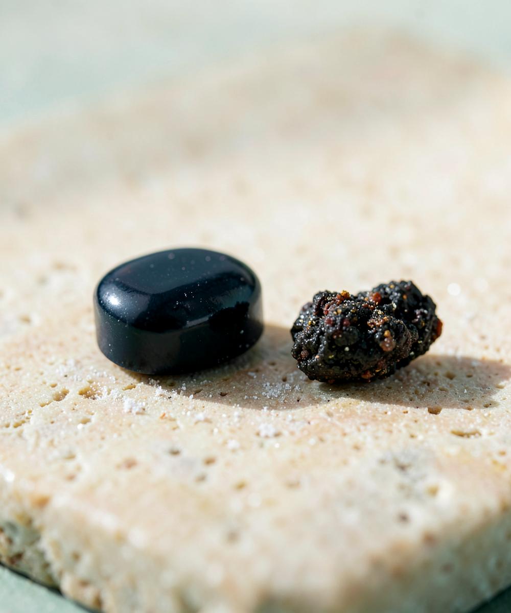 Dark gummy and natural mineral resin on pale stone